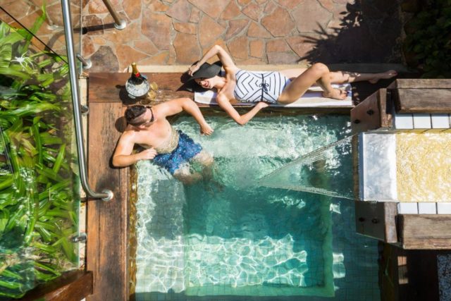 The Reef House couple relaxing by a plunge pool